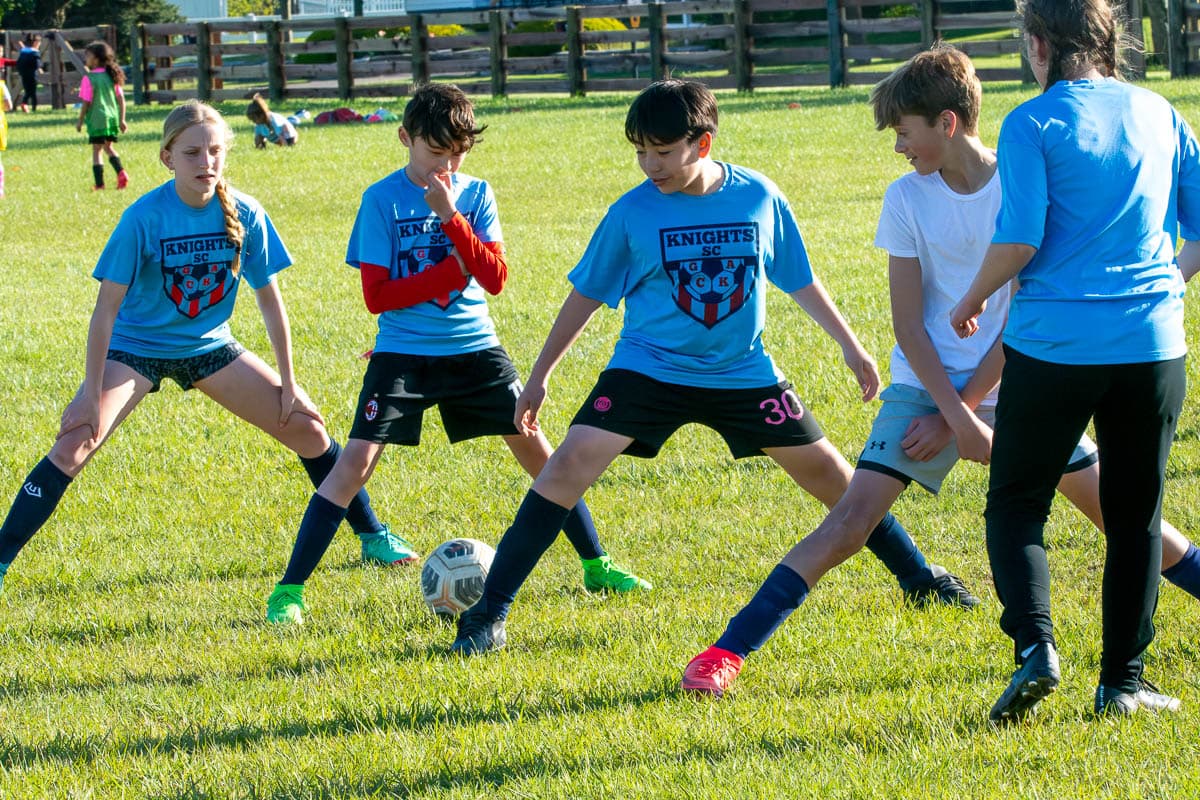 Youth soccer players practicing together outdoors