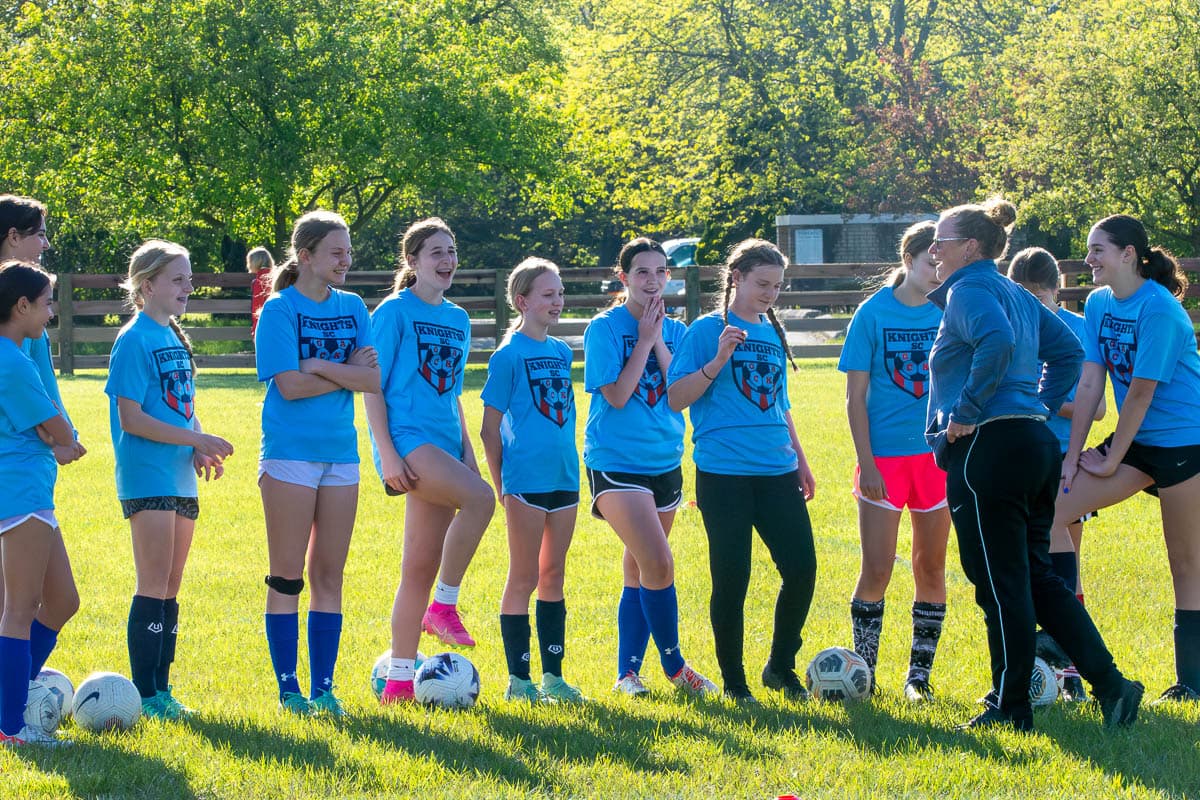 Coach Blount meeting with a group of youth soccer players